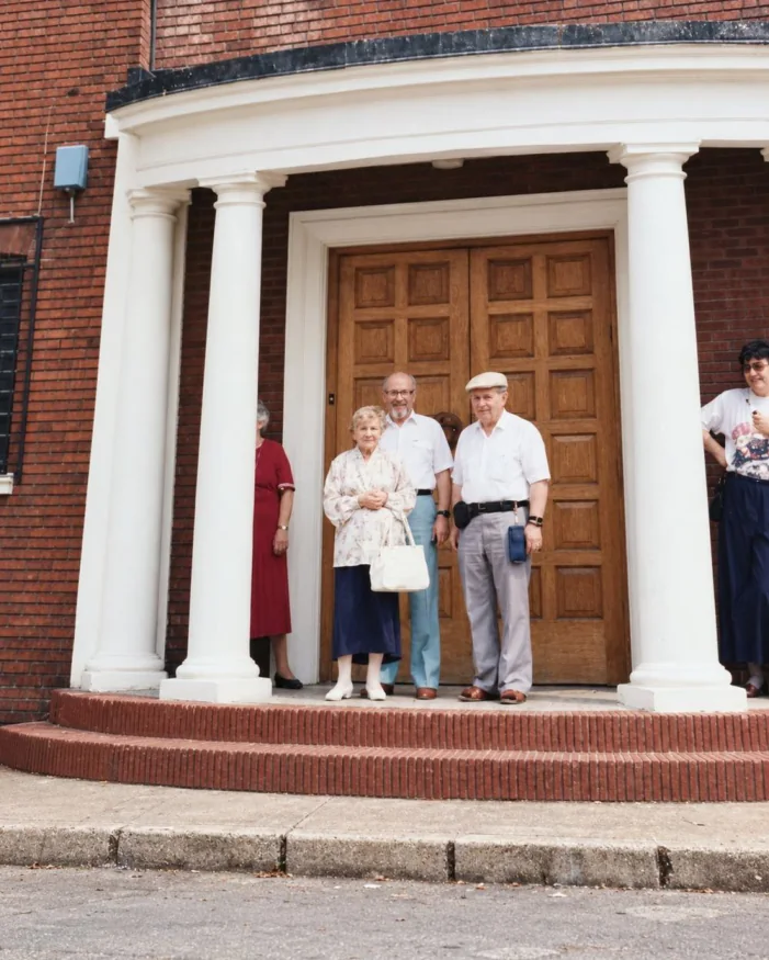 Laya and Yoine on the steps of a shul in Luton.